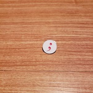 Semicolon brooch
